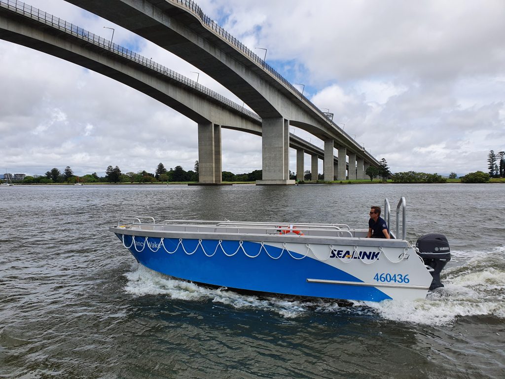 boat tender going under a bridge